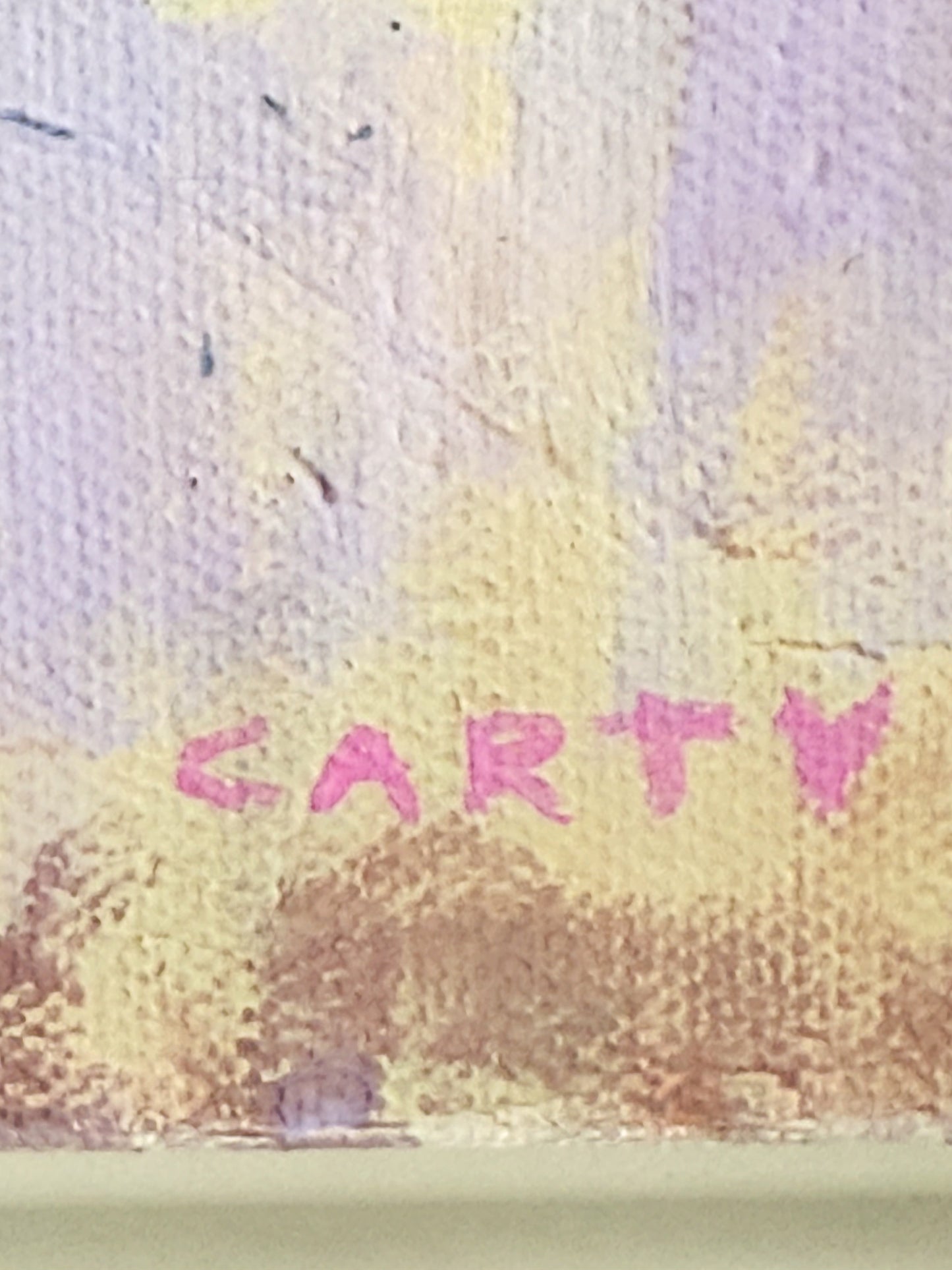 Close-up of a textured surface with 'CARTY' text in pink. megan carty fine art and prints.
