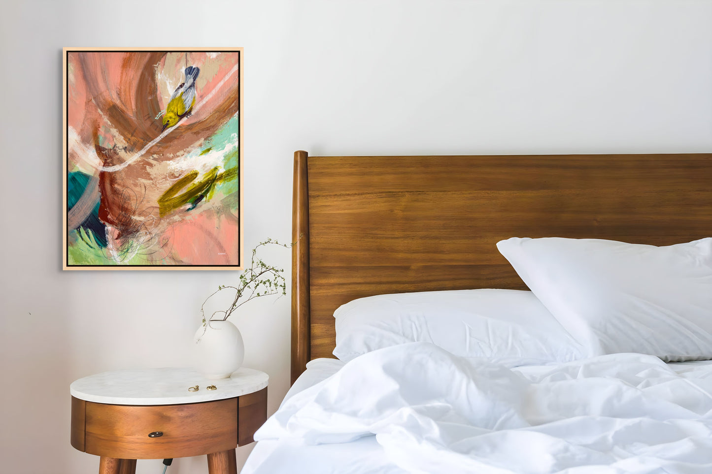 Bedroom with abstract bird painting by New England artist Megan Carty on the wall, wooden headboard, and white bedding.