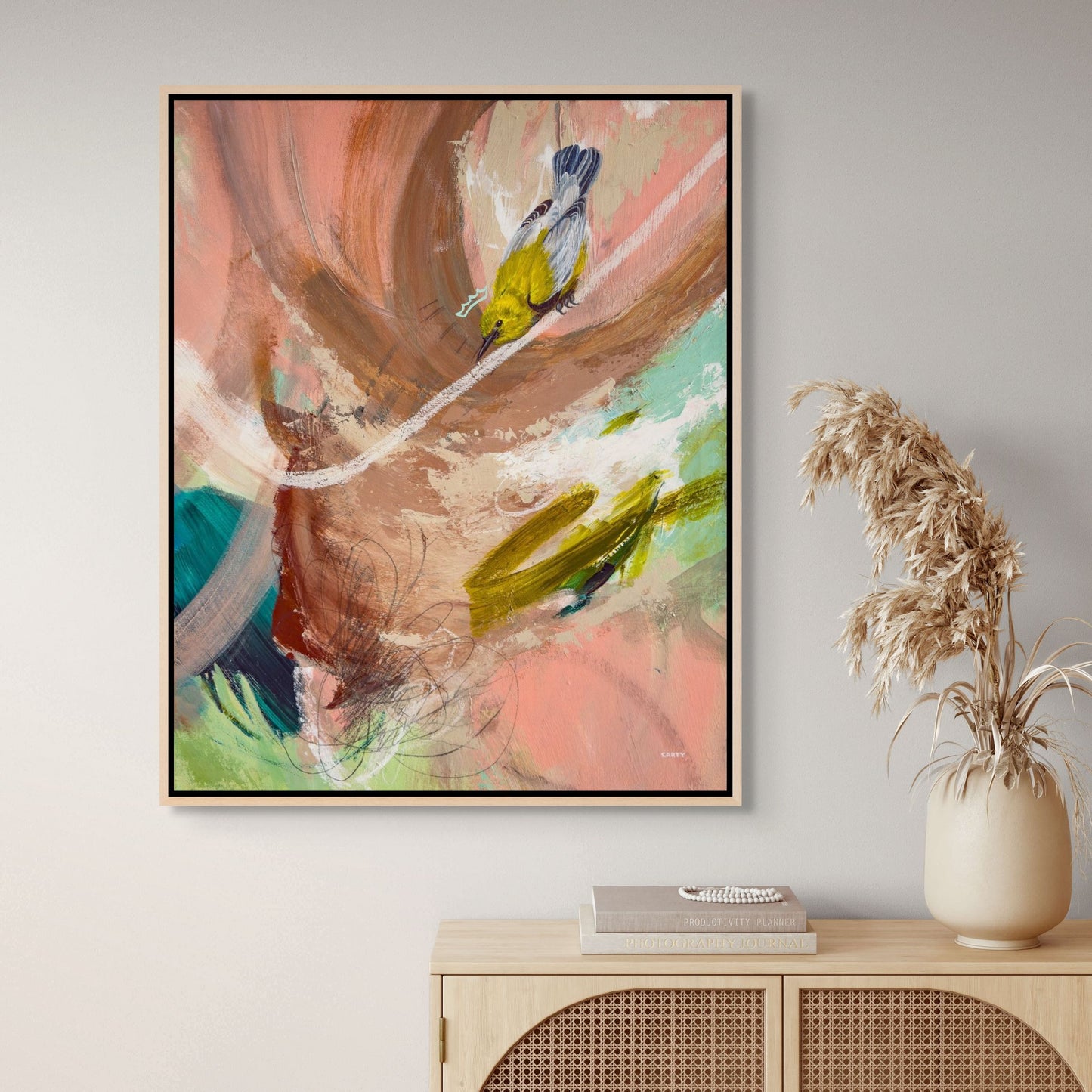 modern abstract bird painting over a boho-style credenza by Boston area artist Megan Carty, yellow warbler