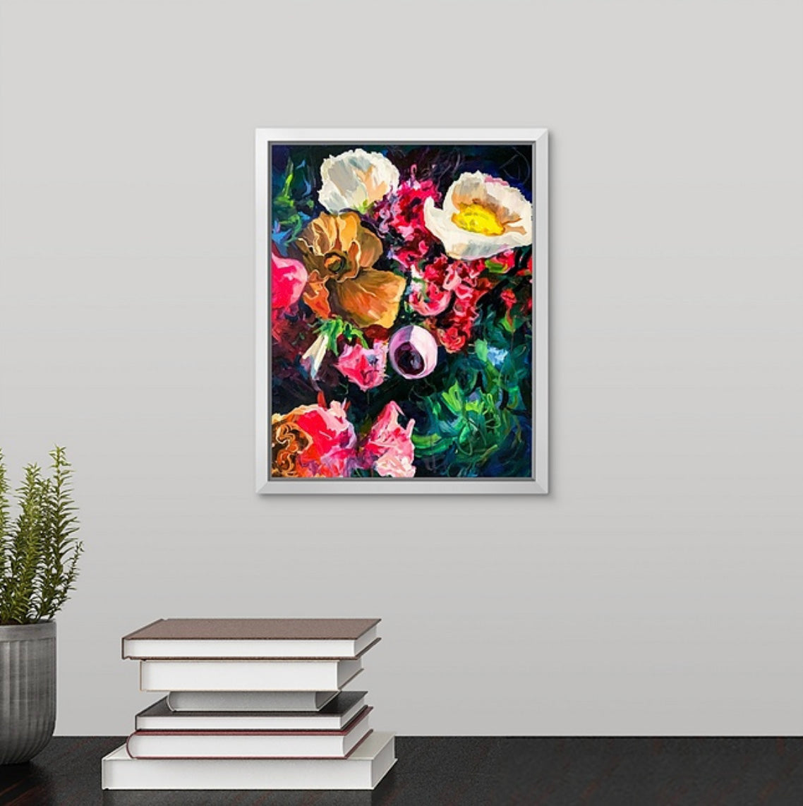Dark moody blue floral painting by Boston area artist Megan Carty on a wall above a desk.