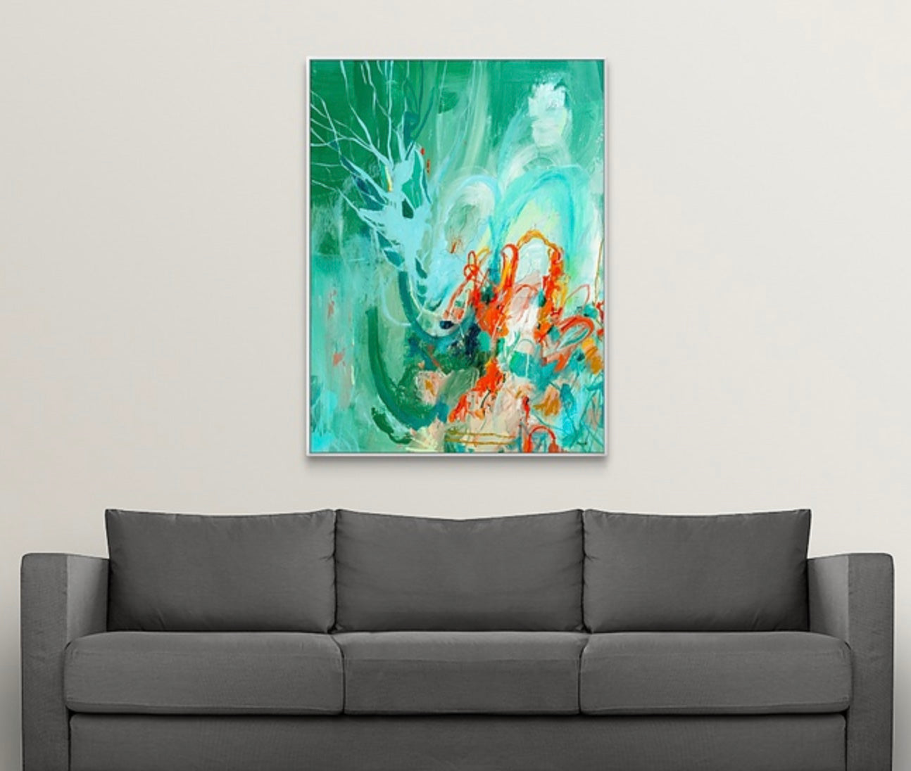 Abstract expressionist painting by Megan Carty on a wall above a gray sofa