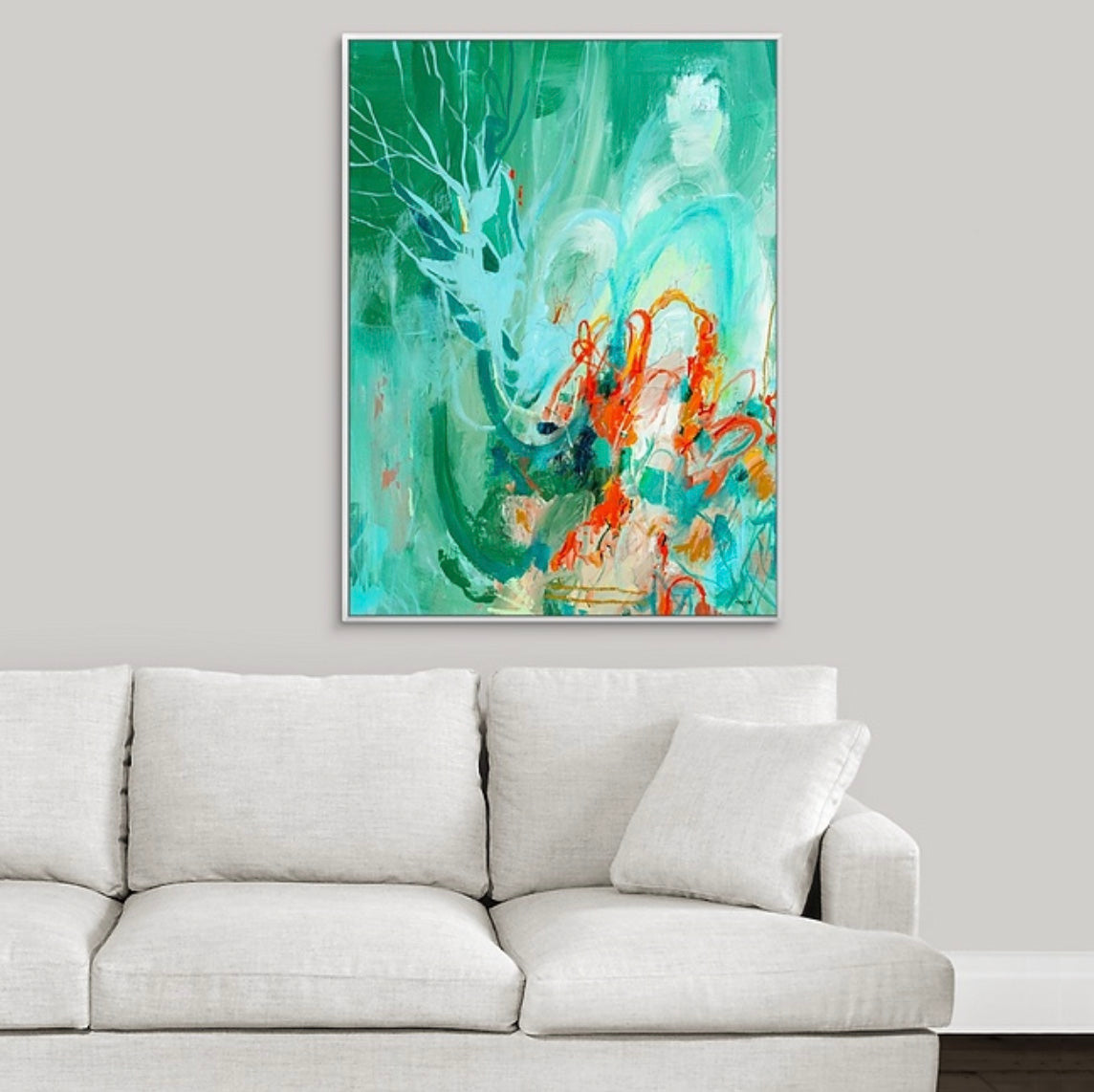 Abstract painting with green and orange colors by boston area artist megan carty above a gray sofa on a white wall