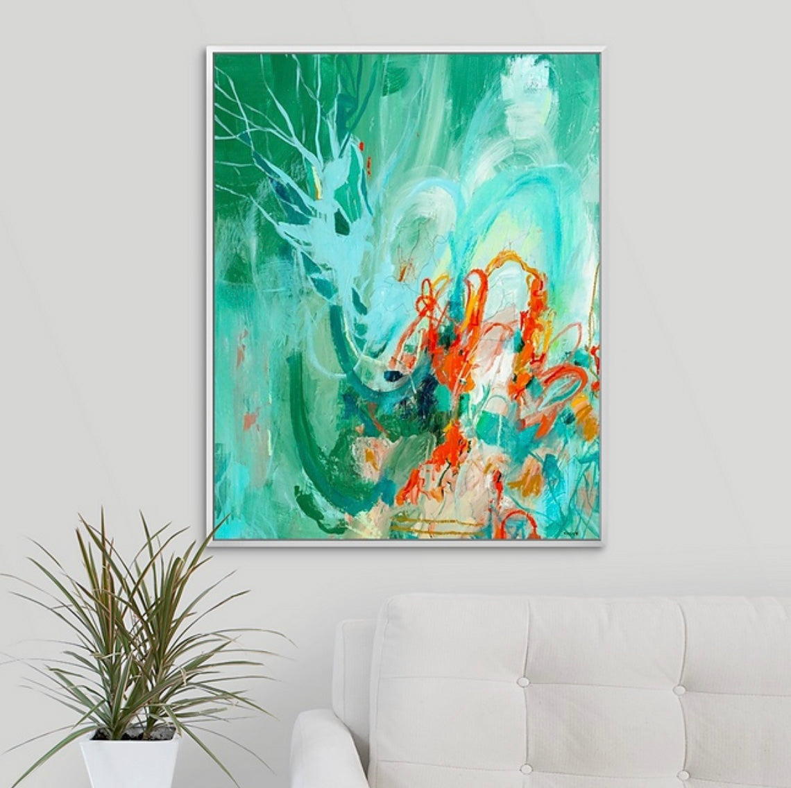 Abstract expressionism painting by New England artist Megan Carty with green and orange tones on a white wall above a sofa.