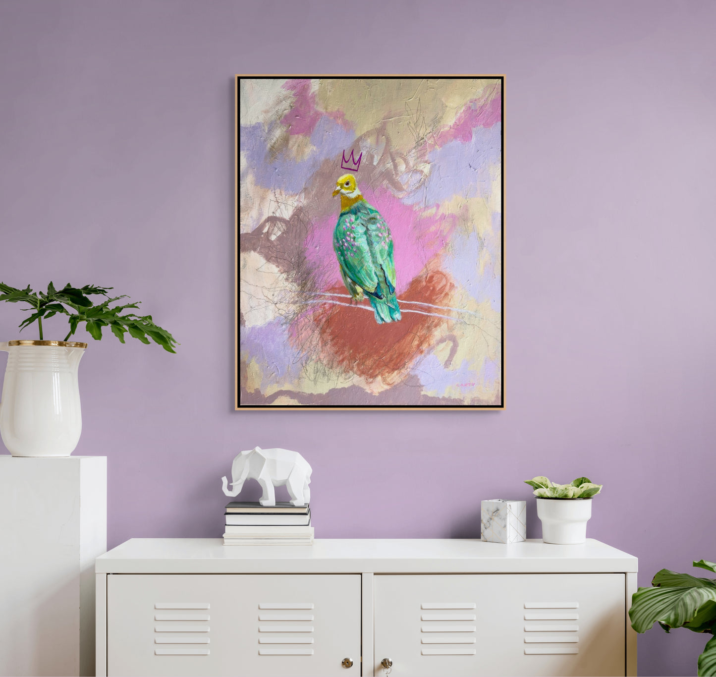 Framed artwork of a colorful fruit dove on a branch against a abstract pink and violet background, painted by New England artist Megan Carty, in a modern teen bedroom.