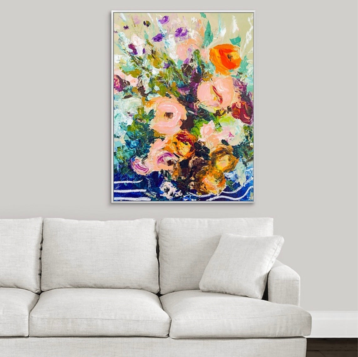 Framed abstract floral painting on a wall above white couch. Painted by New England artist Megan Carty