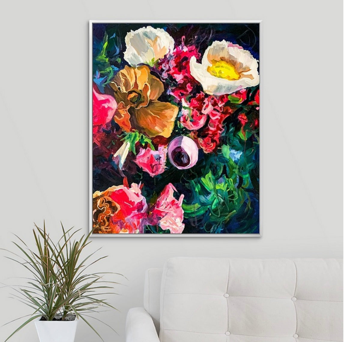 Dark moody blue floral painting by Boston area artist Megan Carty on a wall above a white sofa