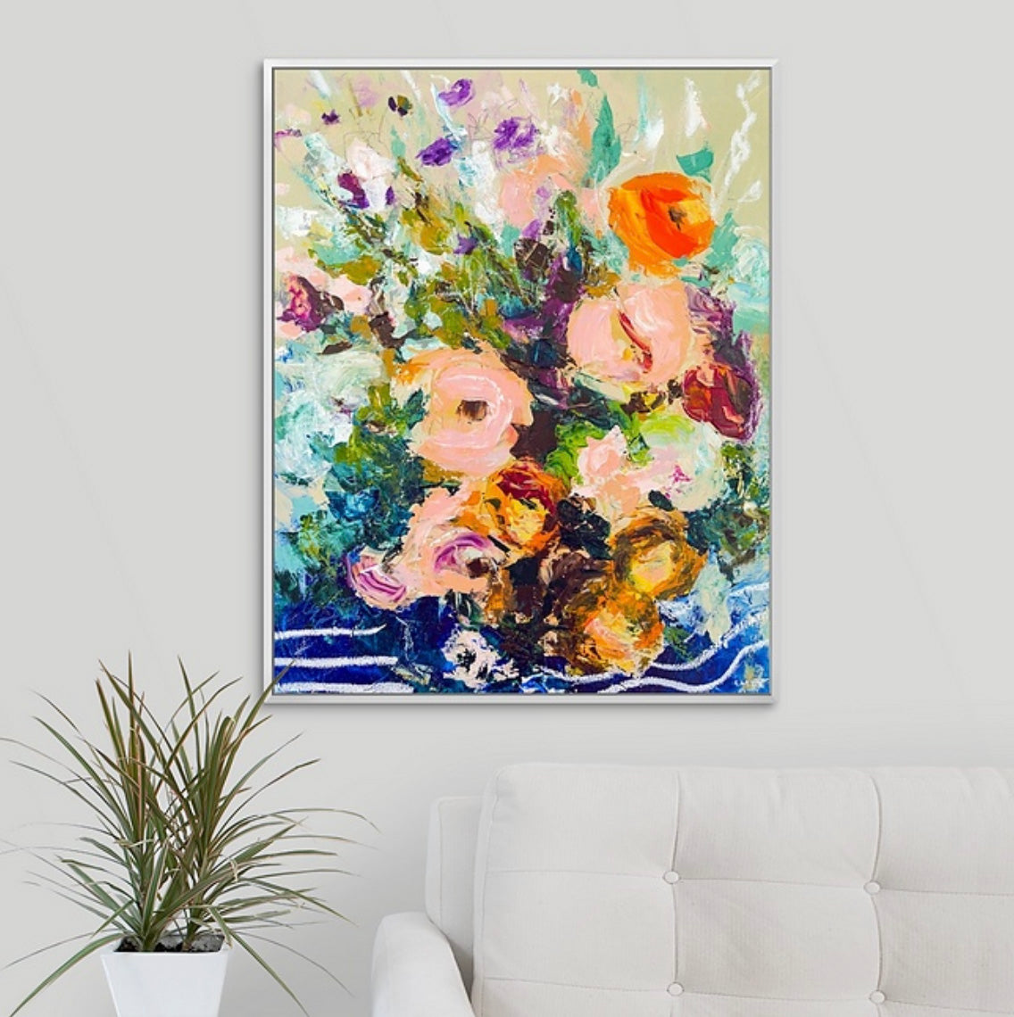 Framed abstract floral painting on a wall above couch and plant. Painted by New England artist Megan Carty