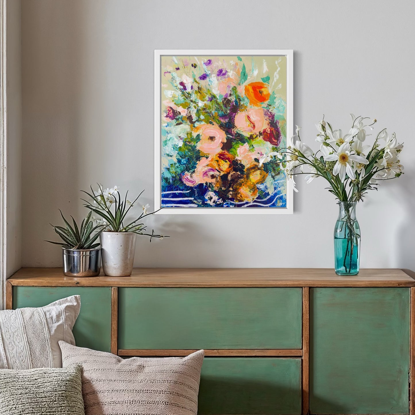 Abstract floral painting detail shot painted by Boston area artist Megan Carty hanging over a green sideboard with flowers.
