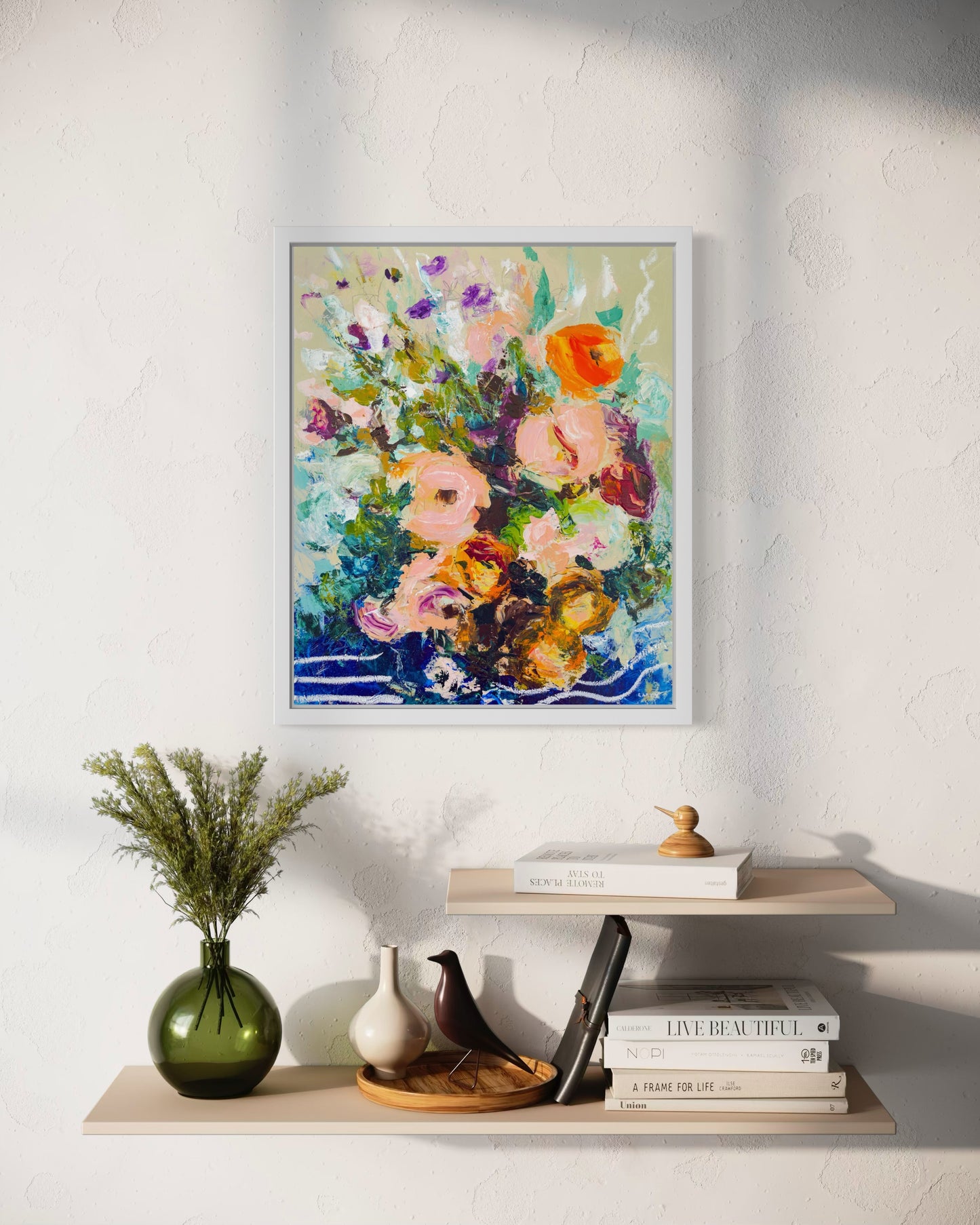 Abstract floral painting painted by Boston area artist Megan Carty hanging over wooden shelves with books, flowers, and figurines.