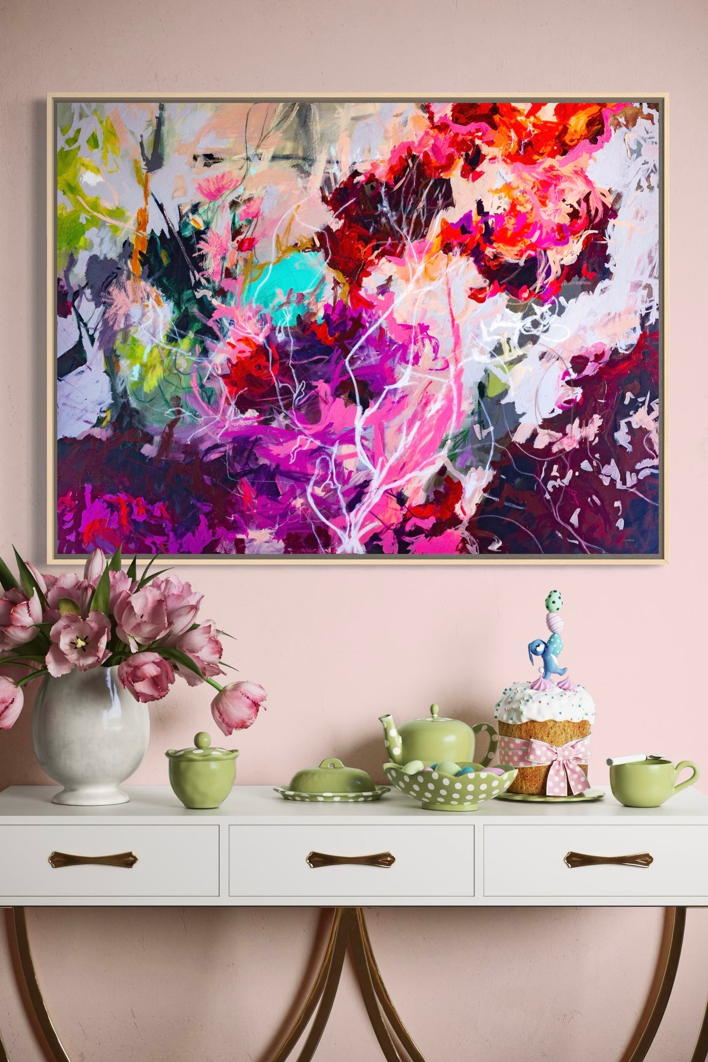 Colorful abstract floral painting wall art print by Megan Carty above a white console table with decorative items.