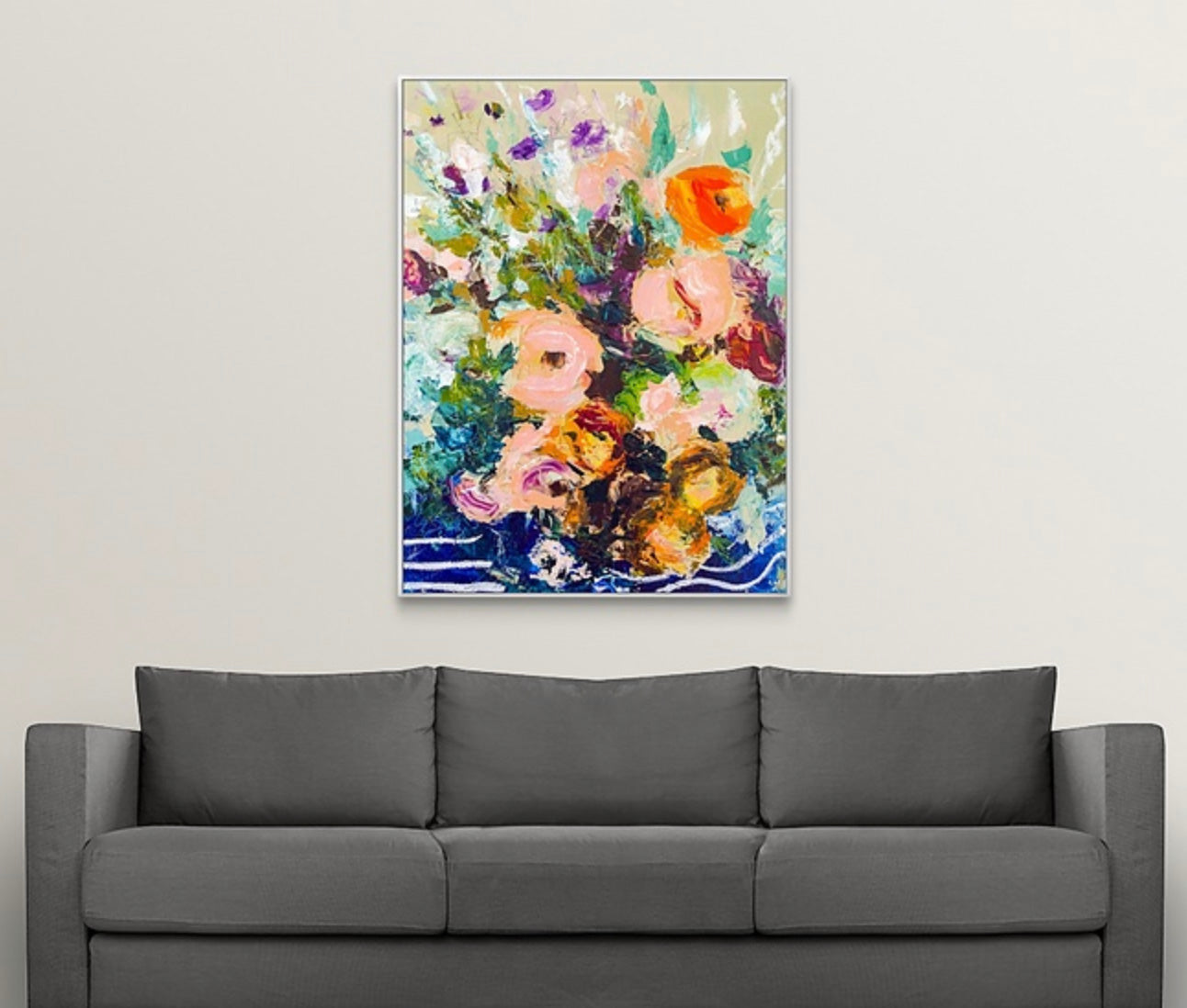 Framed abstract floral painting on a wall above gray couch. Painted by New England artist Megan Carty